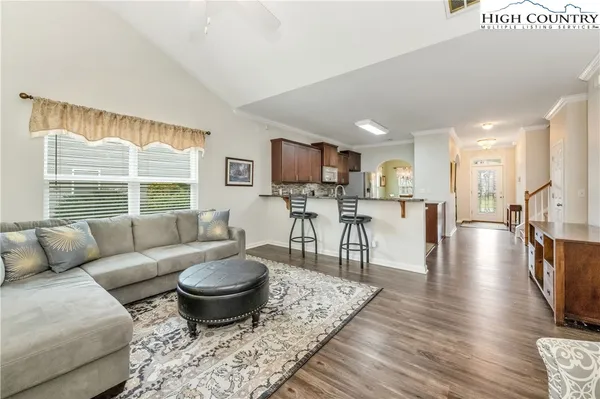 a living room with furniture and a wooden floor