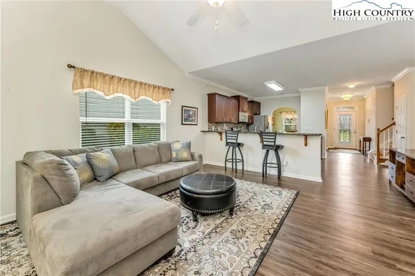 a living room with furniture a window and a table