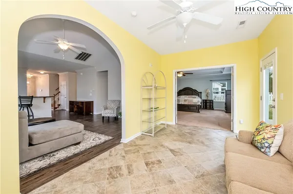 a living room with furniture and a large mirror