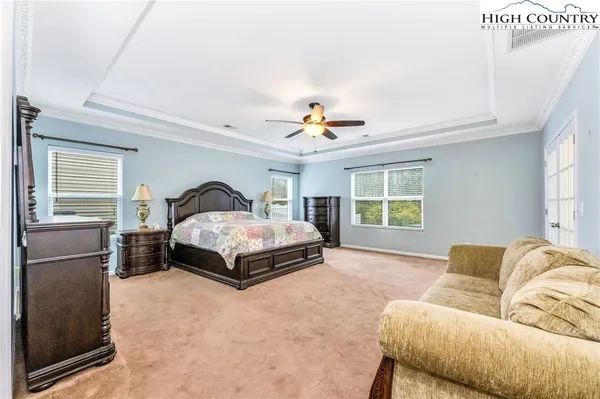 a bedroom with a bed and a couch