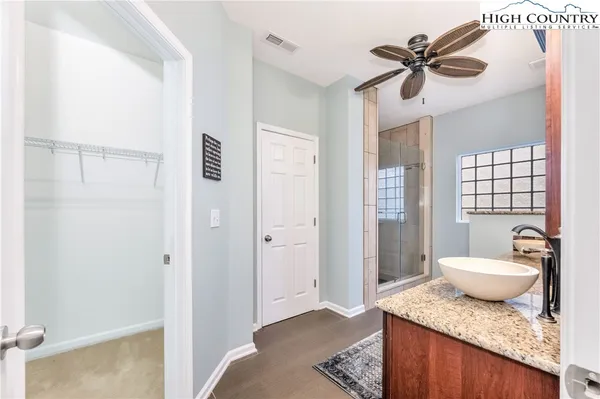 a bedroom with a granite countertop sink a mirror and a toilet