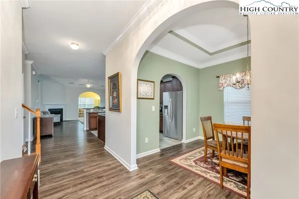 a view of a livingroom with wooden floor and furniture