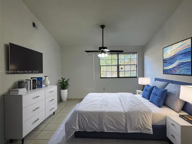 a bedroom with a large bed and a flat screen tv