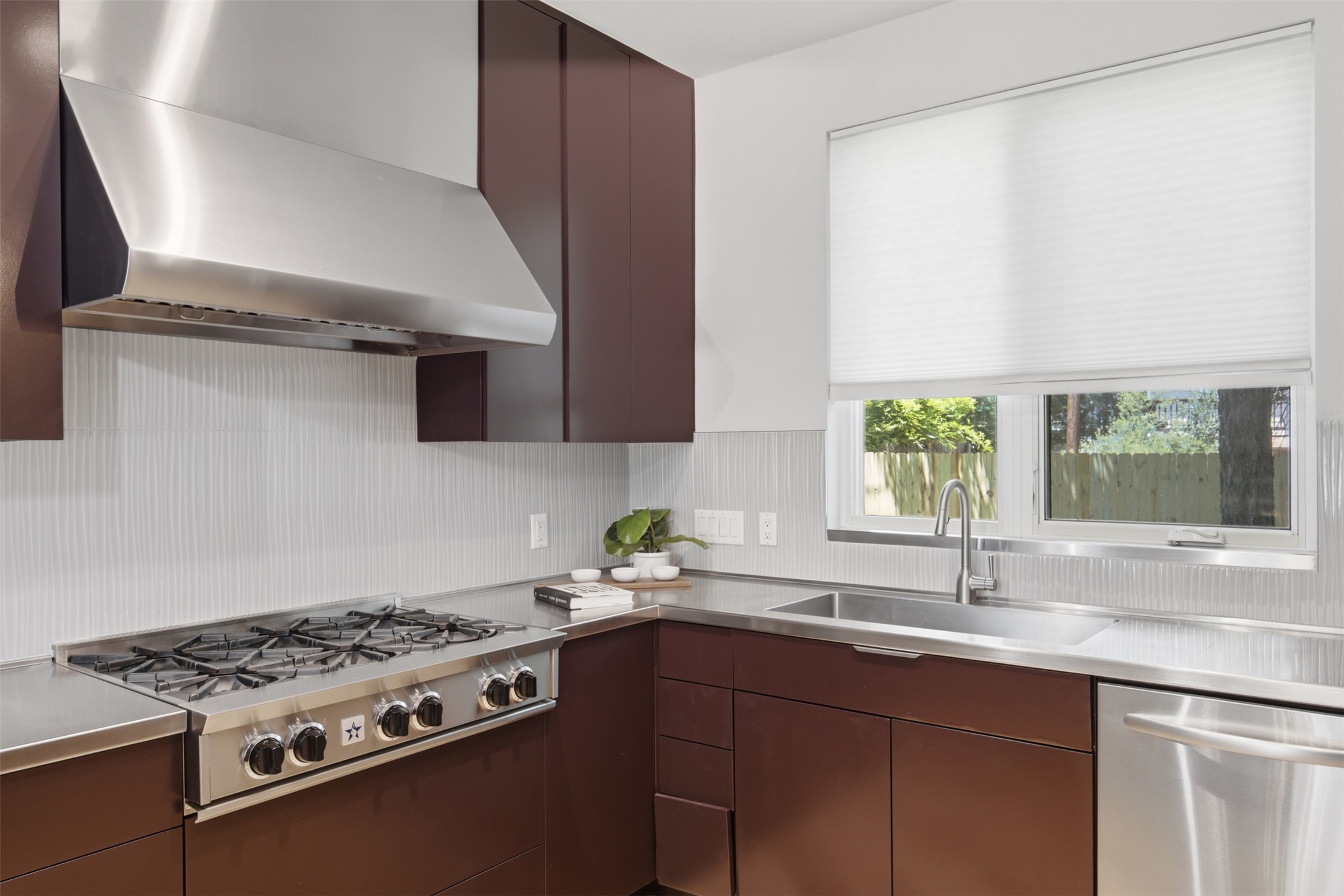 206 East 43rd Street Austin, TX 78751 - Photo 11 of 29 Stainless steel appliances and a view to the backyard from this kitchen windwo.
