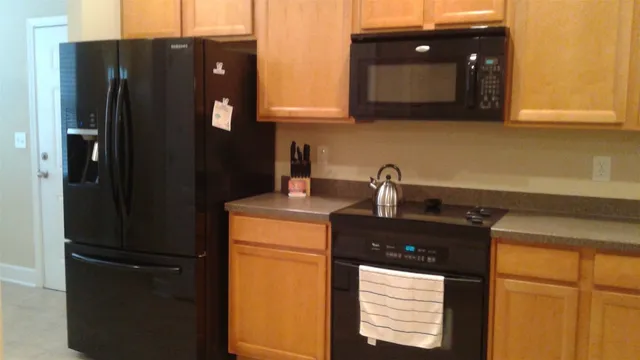 a kitchen with a refrigerator and cabinets