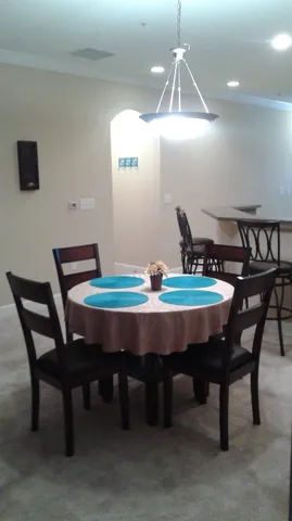 a dining room with furniture and window