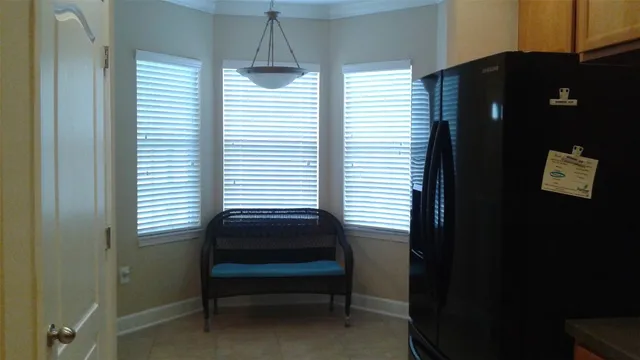 a bedroom with a window and a potted plant