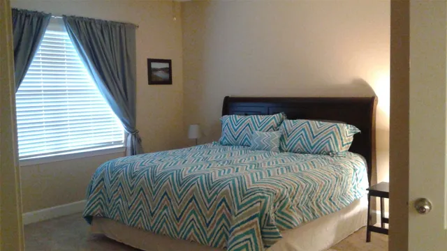 a bedroom with a bed and window