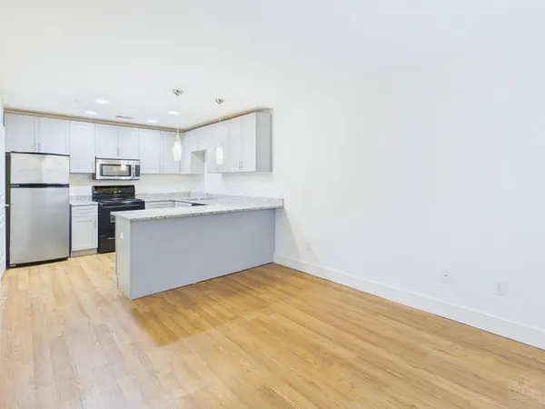 a view of kitchen with wooden floor