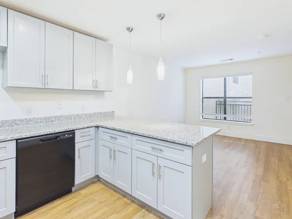 a kitchen with granite countertop white cabinets and white appliances