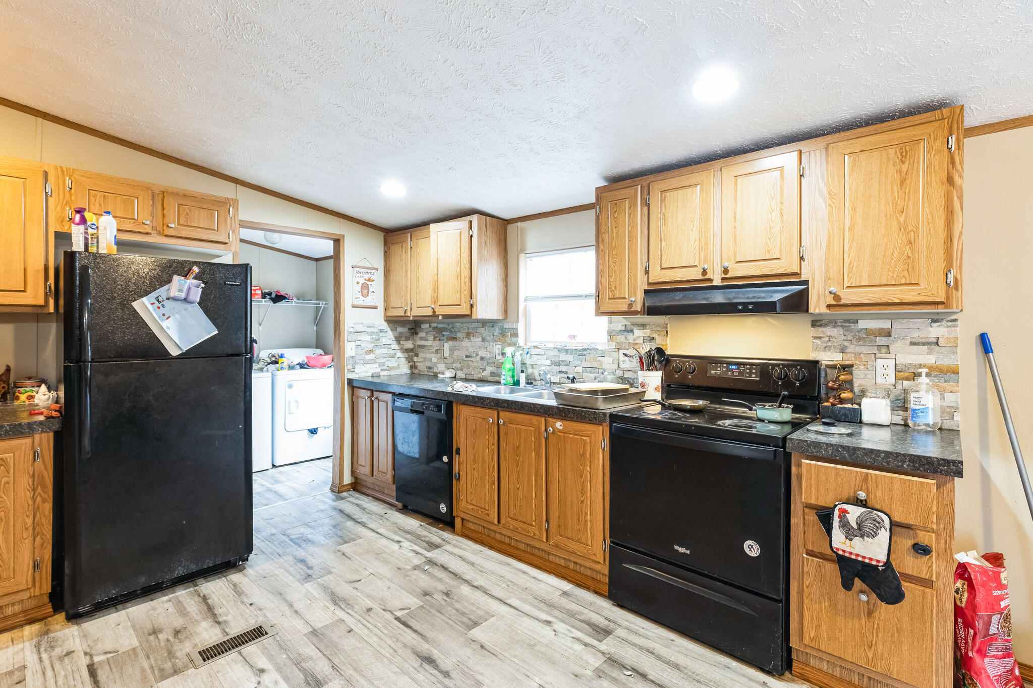 199 Snowden Lane Penhook, VA 24137 - Photo 4 of 15 a kitchen with granite countertop a refrigerator stove top oven and sink
