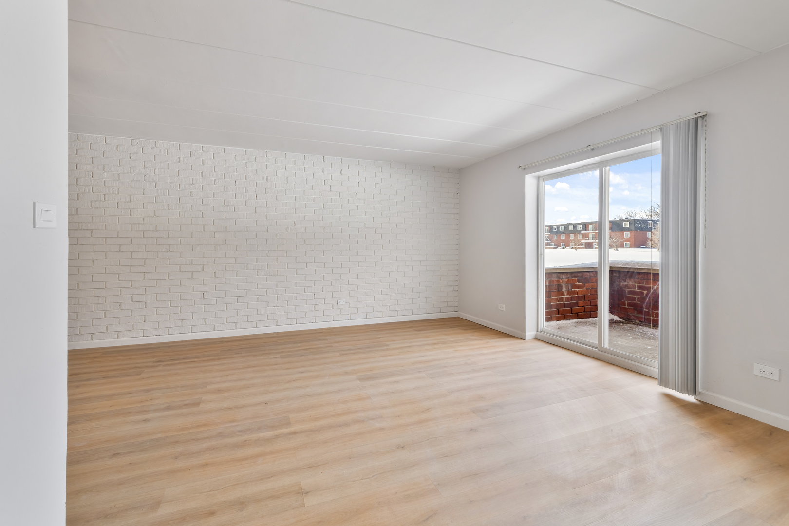 17000 Novak Drive, Unit T105 Hazel Crest, IL 60429 - Photo 3 of 15 an empty room with wooden floor and windows