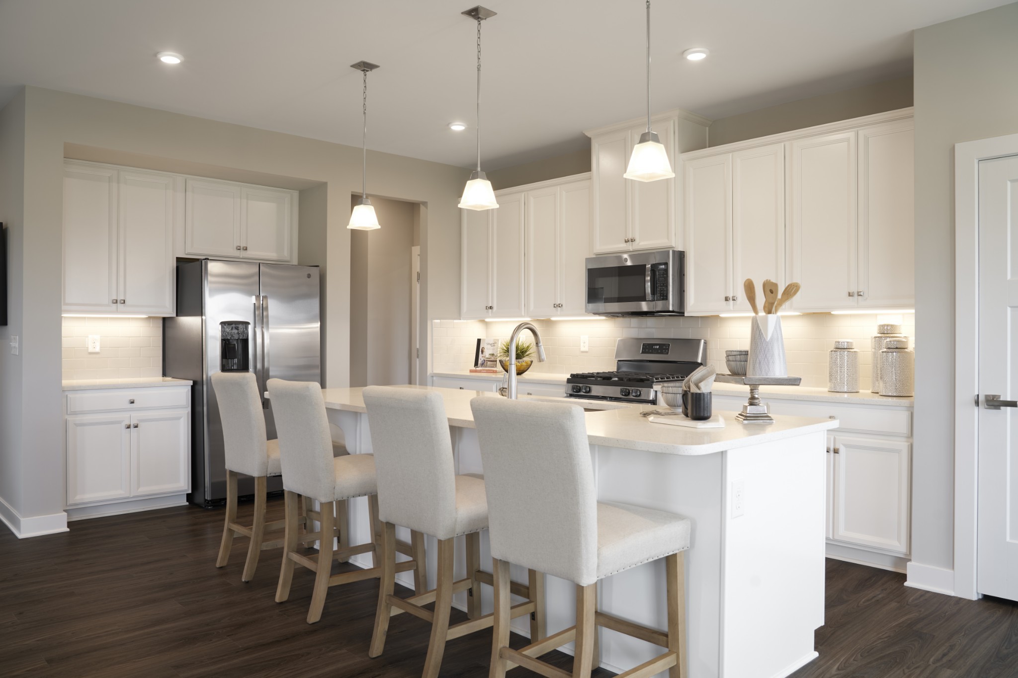 4026 Oglethorpe Drive Franklin, TN 37064 - Photo 15 of 15 a kitchen with refrigerator a stove a microwave oven a sink with island and wooden floor