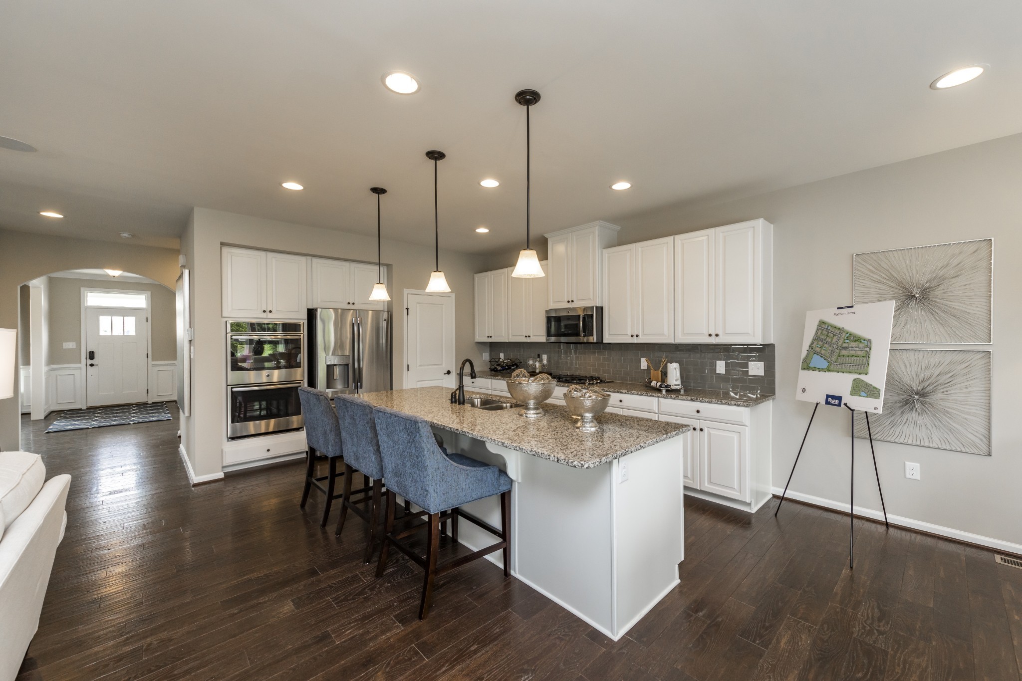 4026 Oglethorpe Drive Franklin, TN 37064 - Photo 4 of 15 a kitchen with stainless steel appliances kitchen island granite countertop a refrigerator a stove a sink a dining table and chairs with wooden floor