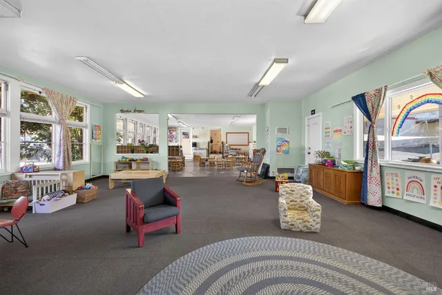 a living room with furniture a rug and a large window