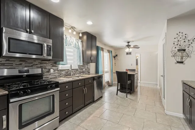 a kitchen with a sink cabinets and stainless steel appliances