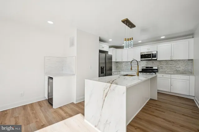a kitchen with a sink a microwave and cabinets