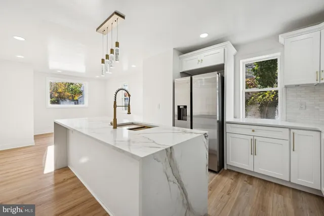 a kitchen with sink stove and refrigerator