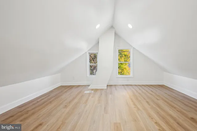 a view of an empty room window and wooden floor