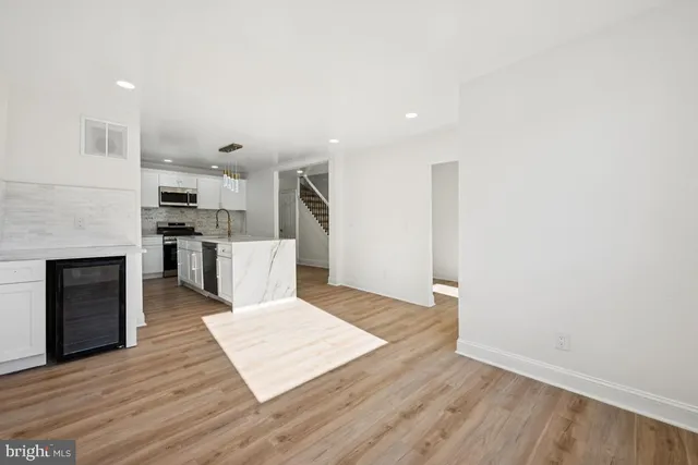 a view of kitchen with cabinets and wooden floor