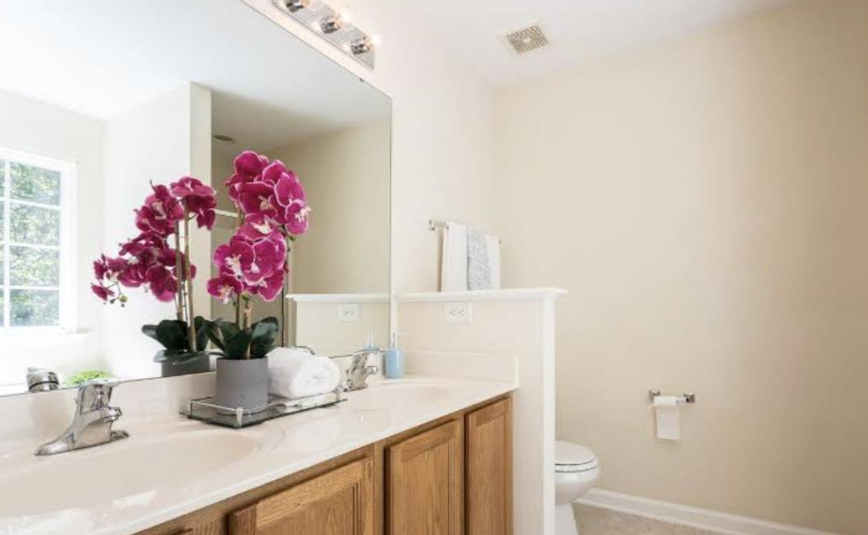 3128 Binghampton Lane Raleigh, NC 27604 - Photo 5 of 9 a bathroom with a sink a vanity and a mirror