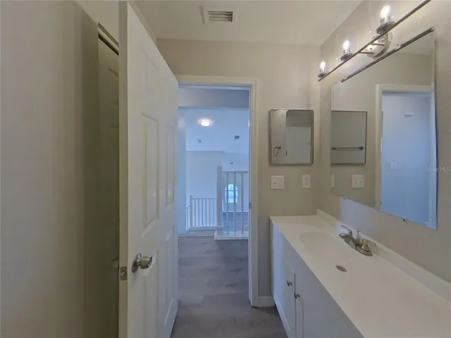 a bathroom with a double vanity sink mirror and shower