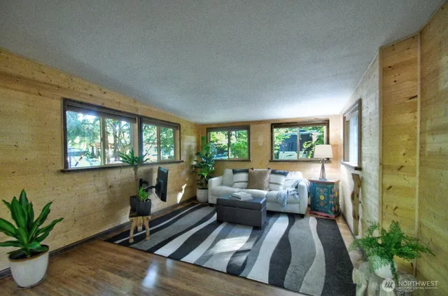 a living room with furniture and a potted plant