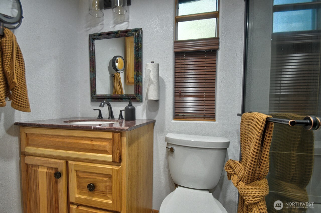 1546 Reservation Road Southeast, Unit 183 Olympia, WA 98513 - Photo 16 of 38 a bathroom with a toilet sink and mirror