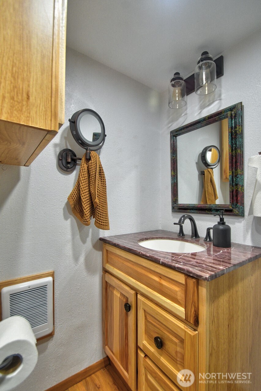 1546 Reservation Road Southeast, Unit 183 Olympia, WA 98513 - Photo 17 of 38 a bathroom with a sink and a mirror