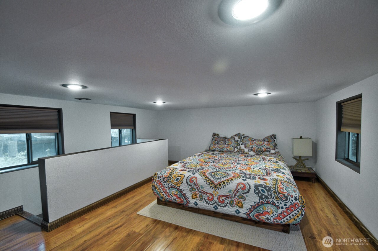 1546 Reservation Road Southeast, Unit 183 Olympia, WA 98513 - Photo 19 of 38 a bedroom with a large bed and a couch