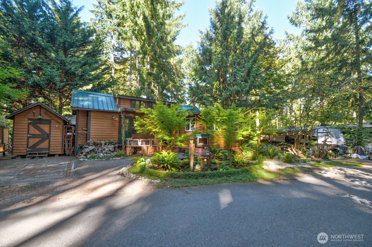 1546 Reservation Road Southeast, Unit 183 Olympia, WA 98513 - Photo 22 of 38 a front view of a house with a yard and garage