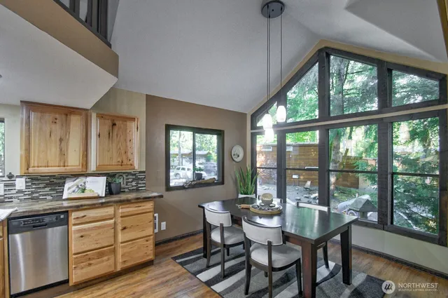 a kitchen with a table chairs and wooden floor