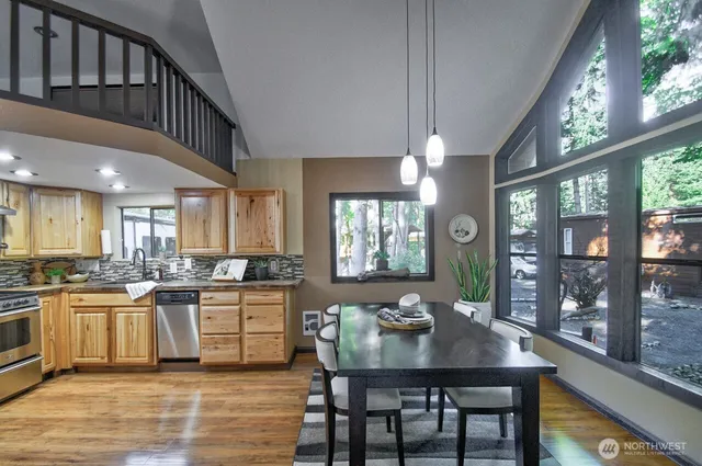a kitchen with a table chairs stove and cabinets
