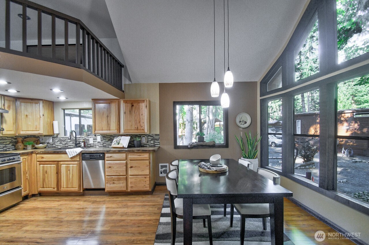 1546 Reservation Road Southeast, Unit 183 Olympia, WA 98513 - Photo 9 of 38 a kitchen with a table chairs stove and cabinets