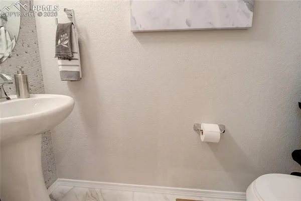 a bathroom with a sink a toilet and mirror