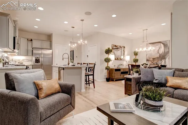 a living room with furniture kitchen view and a dining table