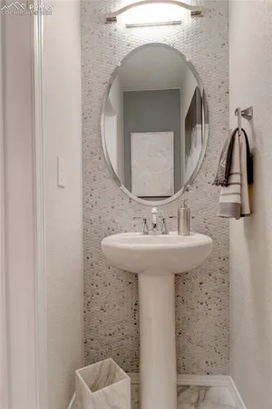 a bathroom with a sink toilet and mirror