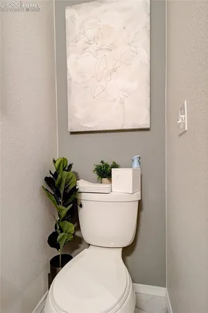 a white toilet sitting next to a bathroom sink