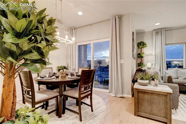 a view of a dining room with furniture and chandelier