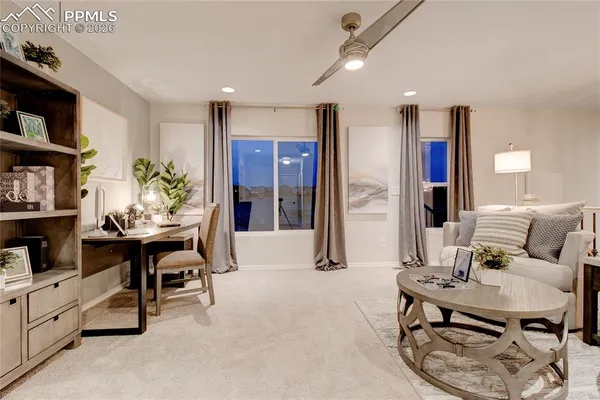 a living room with furniture kitchen view and a fireplace