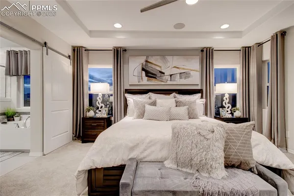 a bedroom with a large bed and a window