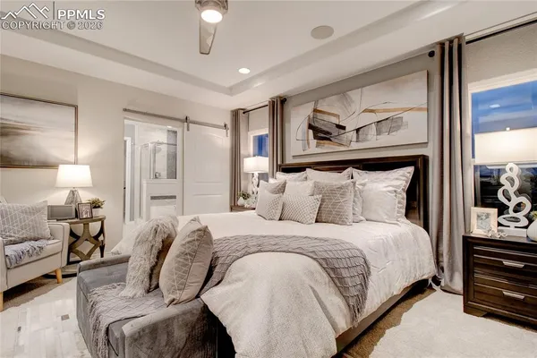 a bedroom with bed and wooden floor