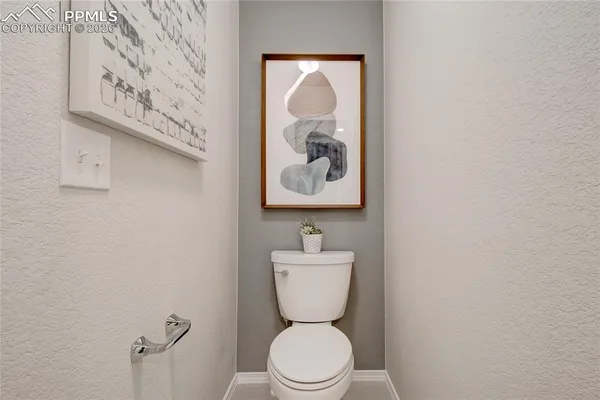 a white toilet sitting next to a bathroom sink