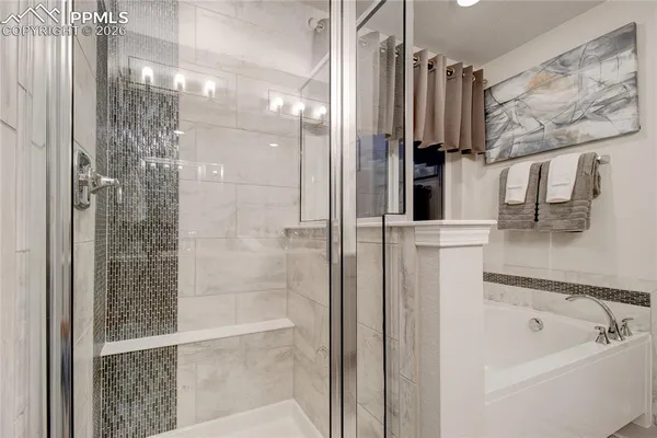 a bathroom with a bathtub and a shower