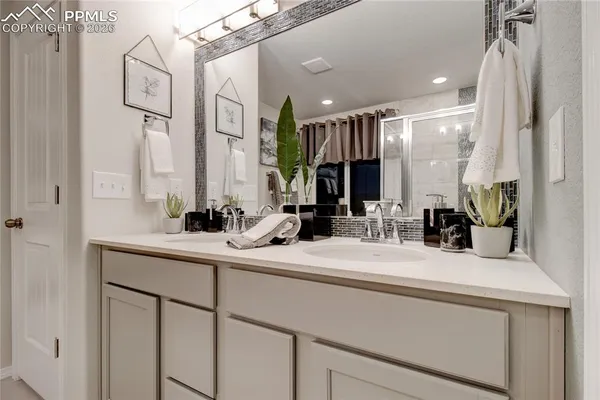 a bathroom with a sink double vanity and a mirror