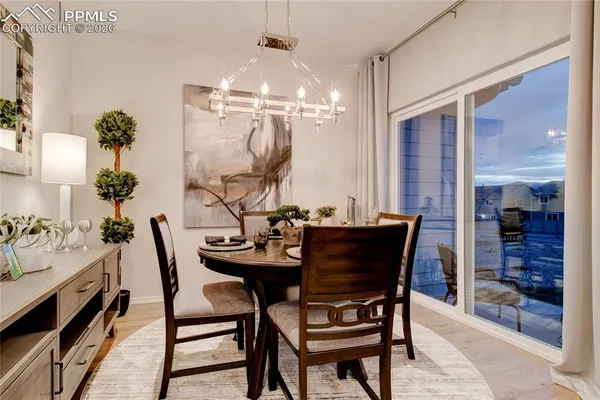 a view of a dining room with furniture and chandelier