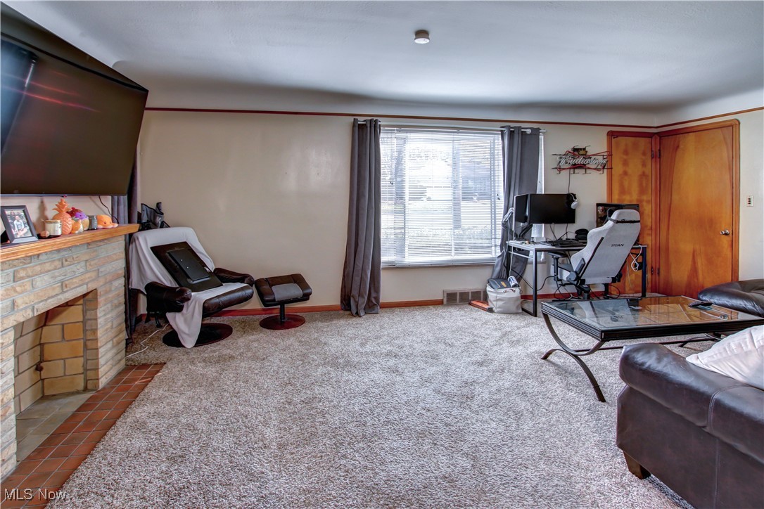 3422 Warren Road Cleveland, OH 44111 - Photo 23 of 32 Living room featuring carpet and a brick fireplace