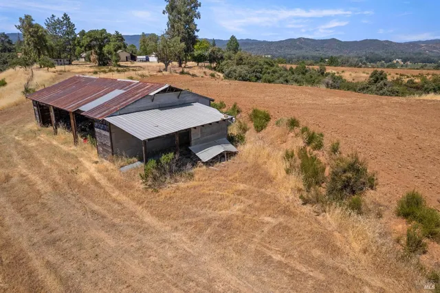 a view of a house with backyard and trees
