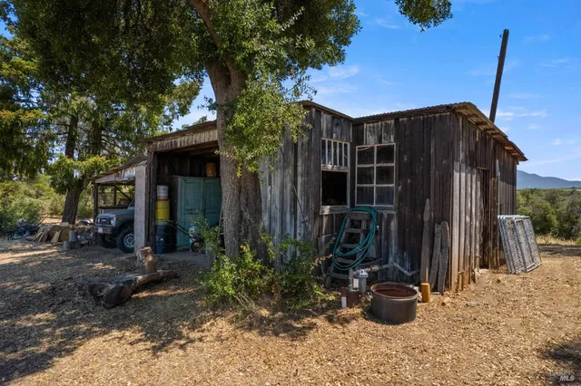 a view of a house with a tree in front