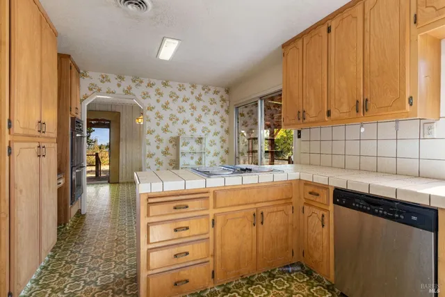 a kitchen with a sink cabinets and appliances
